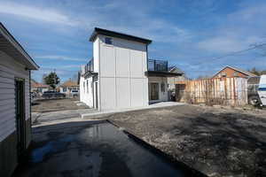 View of outbuilding with fence