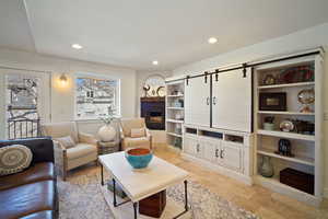 Living area featuring recessed lighting and a fireplace