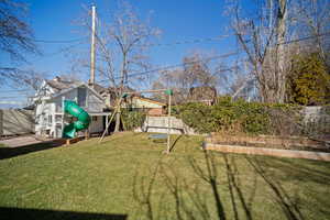 View of yard with a fenced backyard, a vegetable garden, and a playground