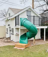 View of play area with a patio, a yard, and fence