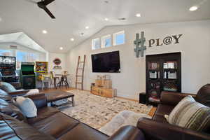 Living room with lofted ceiling, ceiling fan, wood finished floors, and recessed lighting