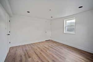 Empty room featuring light wood-type flooring and baseboards