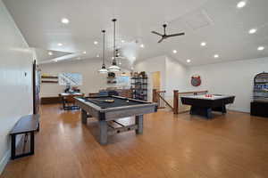 Recreation room with recessed lighting, wood finished floors, billiards, baseboards, and vaulted ceiling