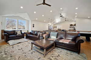 Living area with lofted ceiling, wood finished floors, a ceiling fan, and recessed lighting