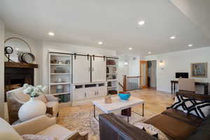 Living area with a fireplace, baseboards, and recessed lighting