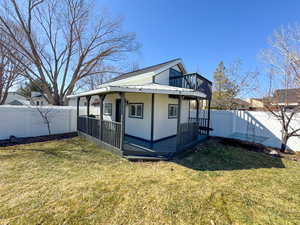 View of side of property with a fenced backyard, metal roof, and a yard