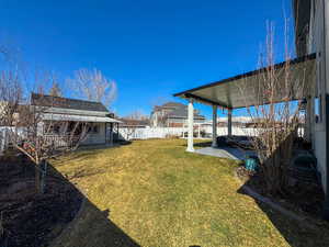 View of yard with a patio area and fence