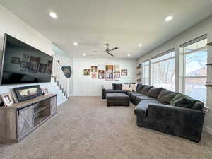 Living area featuring carpet, stairway, baseboards, and recessed lighting