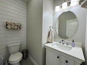 Bathroom featuring baseboards, vanity, and toilet