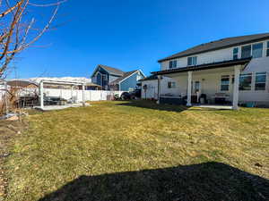 View of yard with a patio area, a fenced backyard, and a residential view