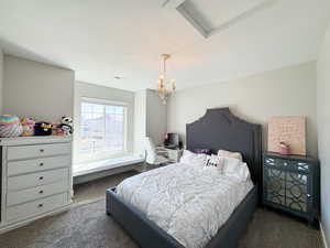 Bedroom featuring a chandelier and carpet