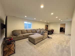 Living room with baseboards, carpet, visible vents, and recessed lighting