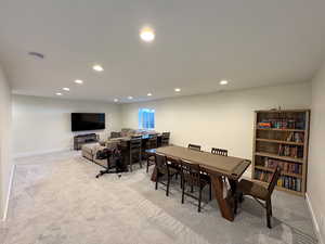 Carpeted dining space featuring recessed lighting and baseboards