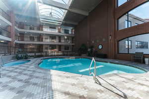 Community pool with fence and a patio