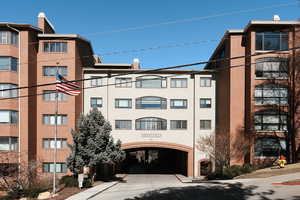 View of building exterior featuring concrete driveway