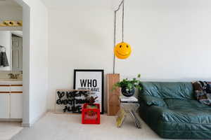 Tiled living area with a sink and baseboards