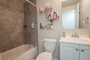 Bathroom with shower / tub combination, vanity, and toilet