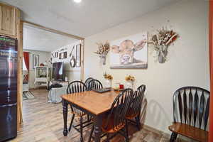 Dining room with light wood-type flooring and baseboards