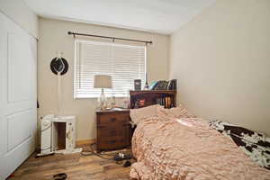 Bedroom with baseboards and wood finished floors
