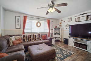 Living area featuring ceiling fan, a textured ceiling, and dark wood finished floors