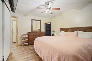 Bedroom with light wood-style floors and ceiling fan
