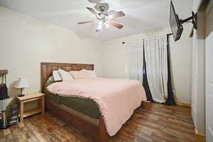 Bedroom featuring ceiling fan, baseboards, and wood finished floors