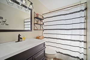 Full bath featuring toilet and vanity