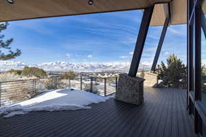 Snow covered deck featuring a mountain view