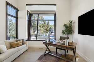 Office with baseboards, visible vents, and light wood finished floors