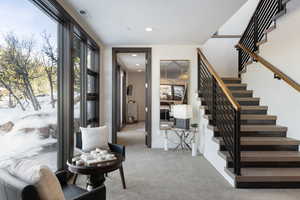 Entrance foyer featuring stairs, recessed lighting, visible vents, and light colored carpet