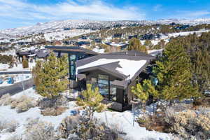 Snowy aerial view featuring a residential view and a mountain view