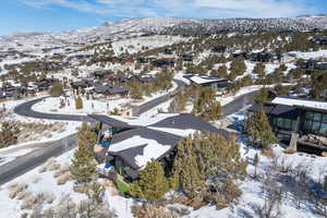 Snowy aerial view featuring a residential view and a mountain view