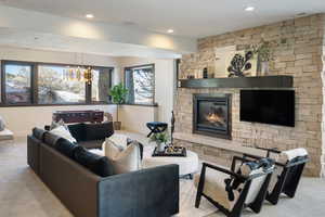 Living area with a fireplace, baseboards, and recessed lighting