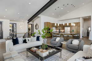 Living area featuring high vaulted ceiling, light wood-type flooring, and recessed lighting