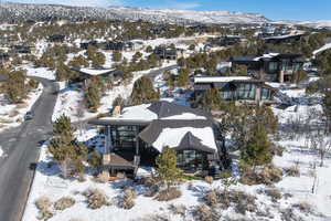 Snowy aerial view featuring a residential view and a mountain view