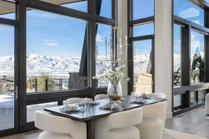 Dining area featuring light wood-style floors, visible vents, and a mountain view