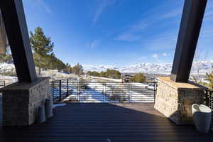 Snow covered deck with a mountain view