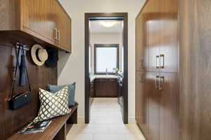 Mudroom featuring light tile patterned flooring and a sink