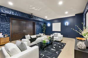 Cinema featuring recessed lighting, an accent wall, carpet flooring, baseboards, and wallpapered walls