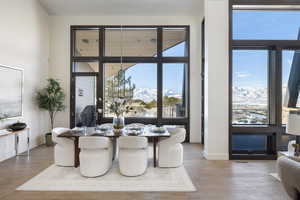 Dining area with visible vents, wood finished floors, a mountain view, and baseboards