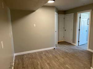 Interior space featuring baseboards and wood finished floors