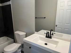 Full bath featuring shower / bath combination, vanity, and toilet