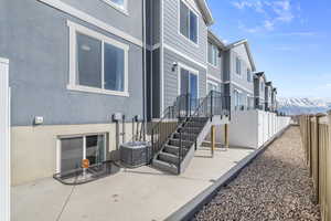 View of home's exterior with a patio, fence, and stucco siding