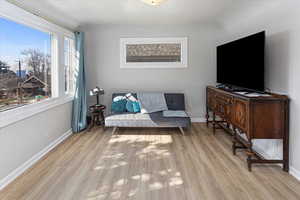 Living area with light wood-type flooring and baseboards