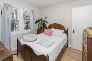 Bedroom with baseboards and light wood finished floors