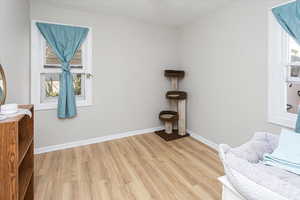 Living area featuring light wood-style floors and baseboards