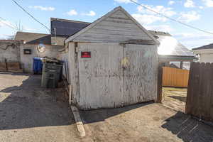 View of outbuilding featuring a fenced backyard and solar panels