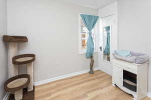 Living area with light wood-style flooring and baseboards