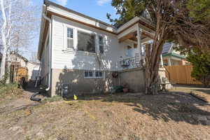 View of front of home featuring fence