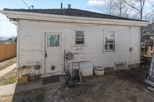 Rear view of property featuring fence